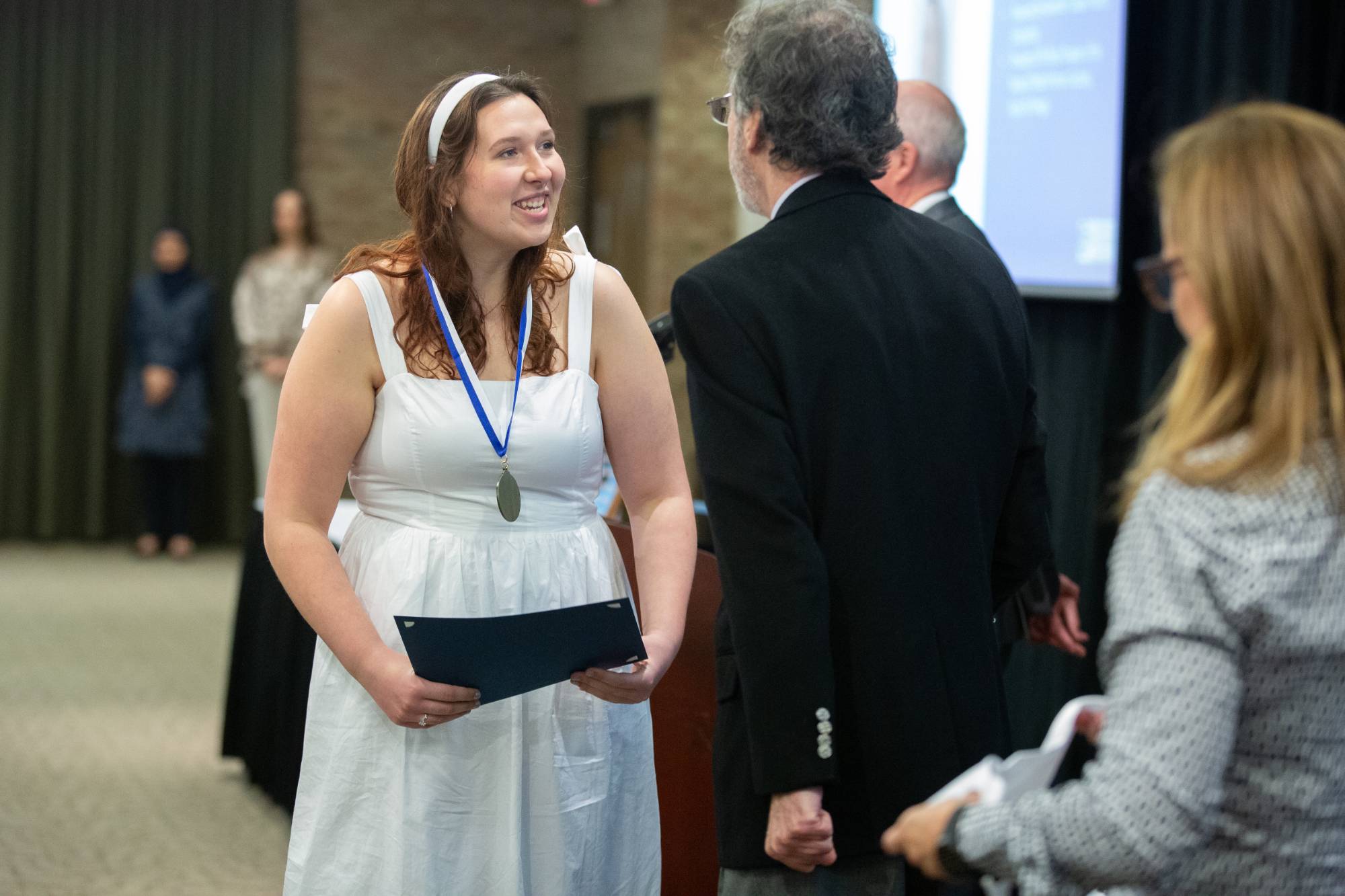 Excited student receives their medallion.